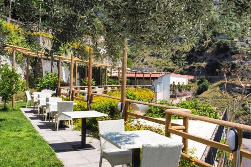 a row of tables and chairs on a patio at Fico D'India Relais in Furore