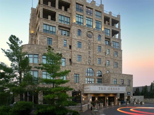 an old stone building with a clock on it at The Oread Lawrence, Tapestry Collection by Hilton in Lawrence