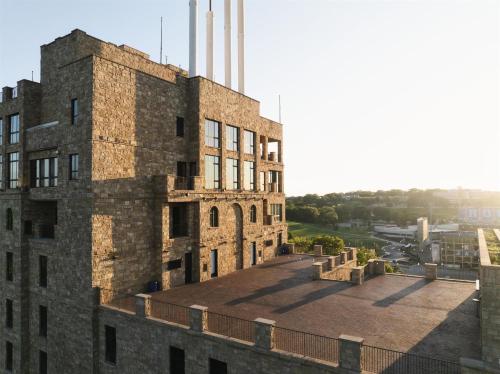 an old brick building with smoke stacks on top of it at The Oread Lawrence, Tapestry Collection by Hilton in Lawrence