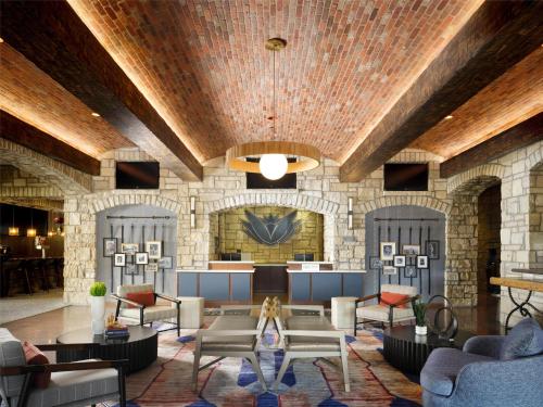 a lobby with couches and tables in a building at The Oread Lawrence, Tapestry Collection by Hilton in Lawrence