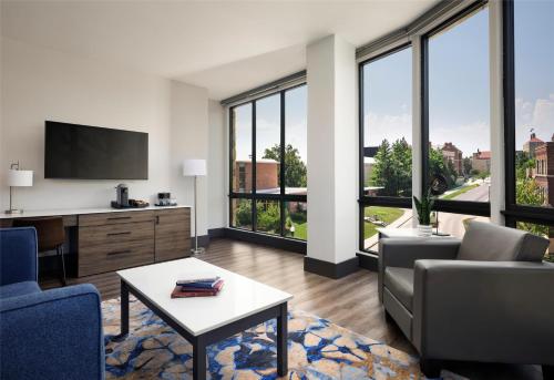 a living room with a couch and a table at The Oread Lawrence, Tapestry Collection by Hilton in Lawrence
