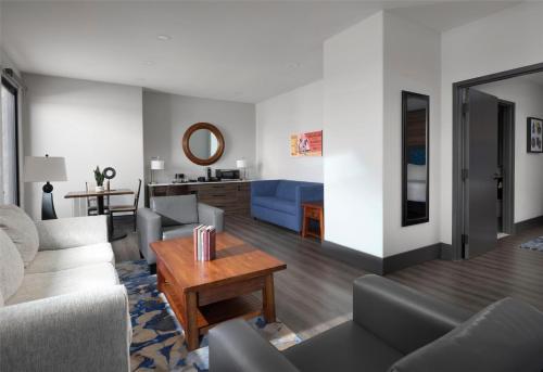a living room with a couch and a table at The Oread Lawrence, Tapestry Collection by Hilton in Lawrence