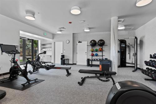a gym with treadmills and cardio equipment in a room at Hotel De Novo Springdale, Tapestry Collection by Hilton in Springdale