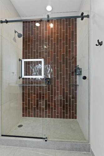 a shower with a glass door in a bathroom at Hotel De Novo Springdale, Tapestry Collection by Hilton in Springdale