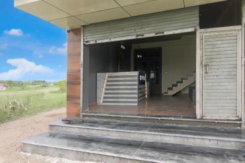 an open door of a building with a staircase at SPOT ON Hotel Global in Rūdarpur