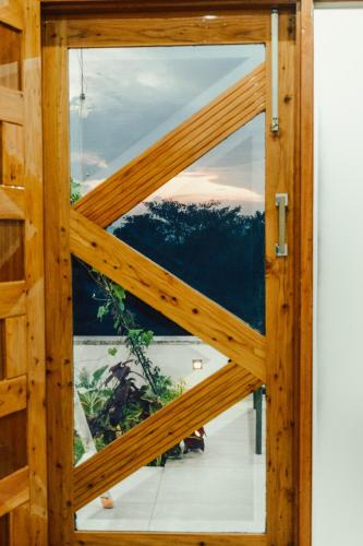 a view through a glass door of a building at JM Luxury Homestays in Jawāla Mukhi