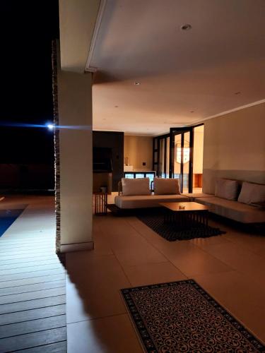 a living room with a couch and a table at Euphoria 447 in Naboomspruit