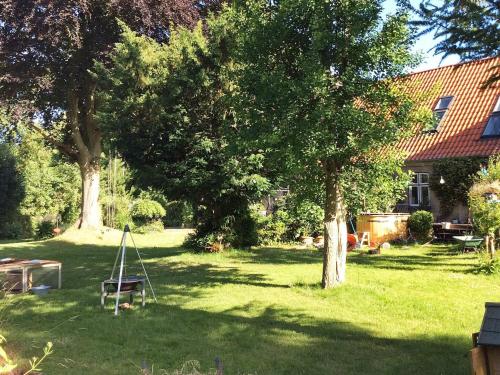a yard with a tree and a frame in the grass at Spacious Cottage Retreat in Sonderborg-By Traum in Sønderborg