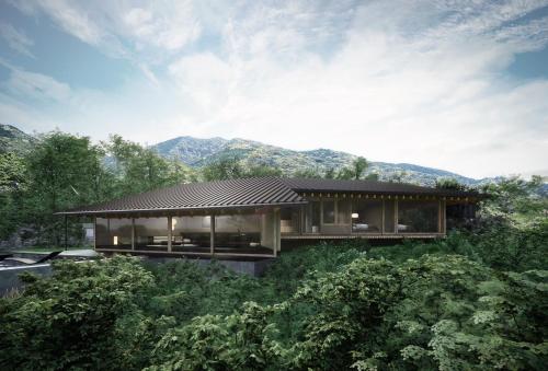 a house on a hill with mountains in the background at WEAZER 西伊豆 in Izu
