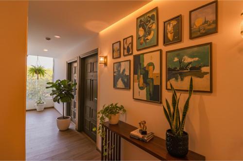 a hallway with a bunch of paintings on the wall at FabHotel Hargobind Enclave in New Delhi