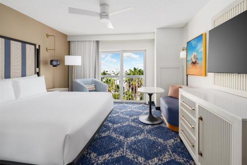 a hotel room with a bed and a balcony at DoubleTree by Hilton Grand Key Resort in Key West