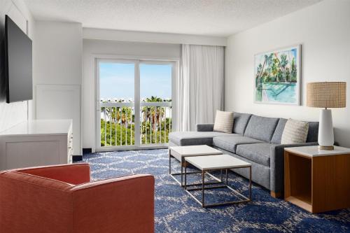 a living room with a couch and a table at DoubleTree by Hilton Grand Key Resort in Key West