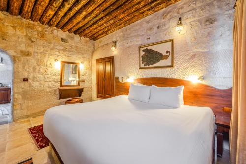 a bedroom with a large white bed in a room at MDC Cave Hotel in Urgup