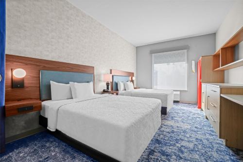 a hotel room with two beds and a kitchen at Home2 Suites By Hilton Pigeon Forge in Pigeon Forge