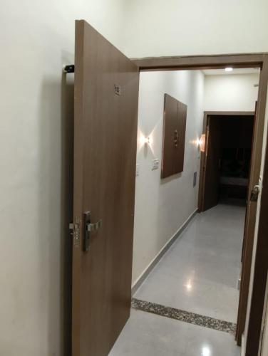 an open door to a hallway with a hallway leading to a room at Gray Stone- Two mints by walk From Golden Temple in Amritsar
