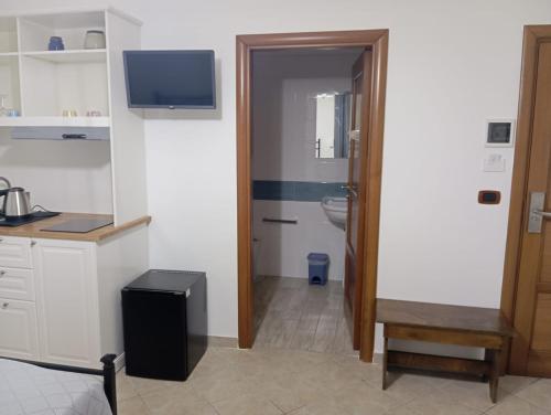 a bathroom with a sink and a toilet and a television at Regency House Accoglienza in Portici
