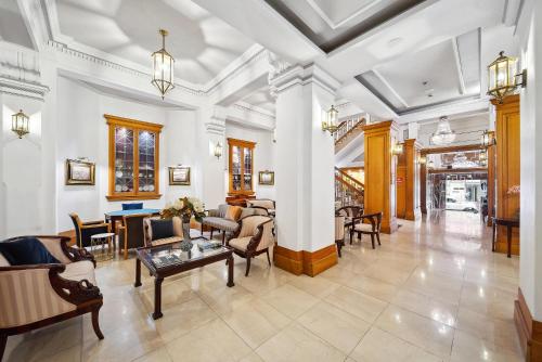 a living room with couches and chairs and a table at Castlereagh Boutique Hotel, an Ascend Collection Hotel in Sydney