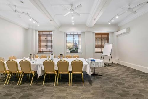 a meeting room with a long table and chairs at Castlereagh Boutique Hotel, an Ascend Collection Hotel in Sydney