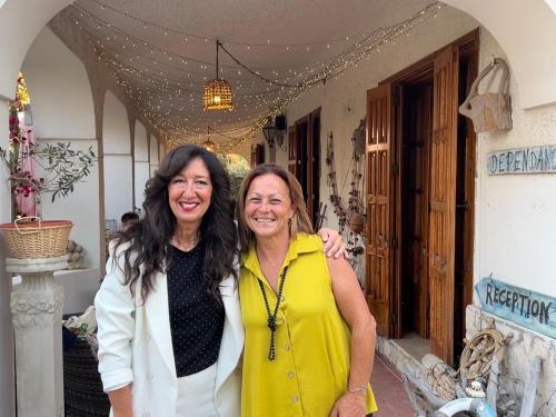 two women are standing outside of a building at Villa Anna GuestHouse in Brindisi