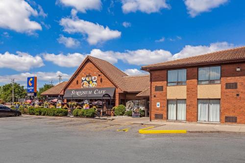 a shopping center with a snowomy cafe in a parking lot at Comfort Inn in Brantford