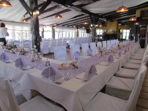 a row of tables and chairs in a marquee at Črni Baron Pension Black Baron in Maribor