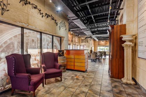 a lobby with two chairs and a table at Comfort Inn in Brantford
