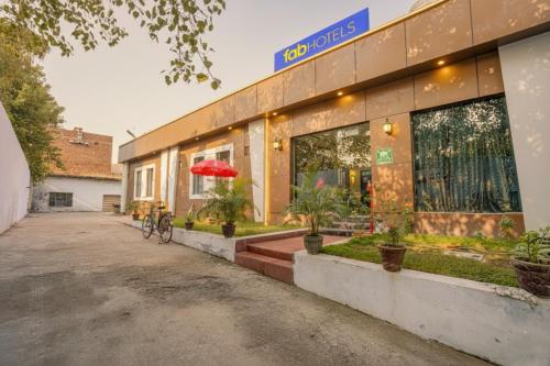 a building with a bike parked outside of it at FabHotel Grand Inn in Jalandhar