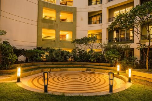 a circular labyrinth in front of a building at night at FabHotel Prime Indeedcare Hotel & Resorts - Nr Kolkata Airport in Jojera
