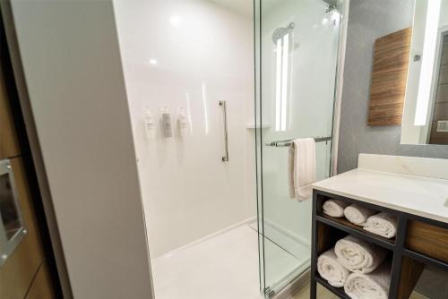 a bathroom with a glass shower and a sink at Hilton Garden Inn Dayton Downtown in Dayton
