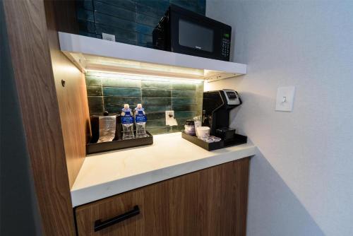 a bathroom with a counter with bottles of water on it at Hilton Garden Inn Dayton Downtown in Dayton