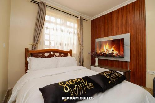 Ένα ή περισσότερα κρεβάτια σε δωμάτιο στο KENKAM suites