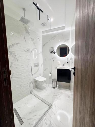 马拉喀什Appartement de Luxe 3 Chambres avec piscine au centre的带马桶和水槽的白色浴室