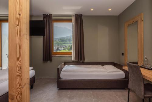 Una cama o camas en una habitación de Hotel Vittoria - Ricarica l'anima