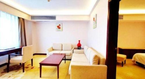 a living room with a couch and a table at Starmoon Hotel in Beijing