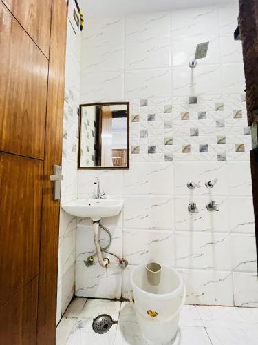 a bathroom with a toilet and a sink at Anmol Residency- near Saket Metro Station in New Delhi