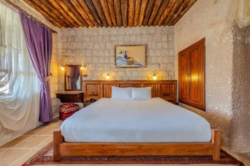 a bedroom with a large bed in a room at MDC Cave Hotel in Urgup