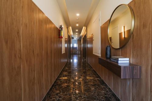 a hallway with wooden walls and a mirror on the wall at FabHotel Prime The Royal Galaxy in Udaipur