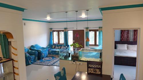 a living room with a fish tank in a room at Happy Villa By Eden Luxury Stay in Ooty
