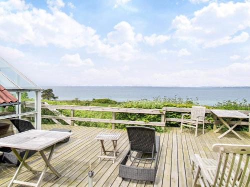 Asnæsにある5 person holiday home in Asnæs-By Traumの海を望むデッキ(テーブル、椅子付)