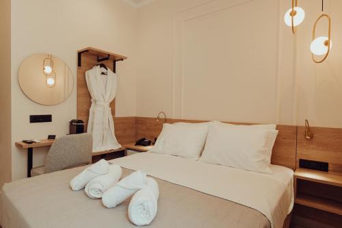 a bedroom with a bed with white towels on it at The Lakehouse in Limne