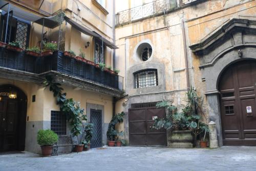 an old building with doors and potted plants on it at The Lodge in Naples