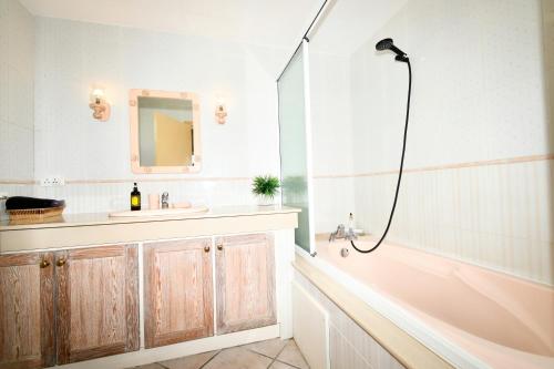 a bathroom with a tub and a sink and a shower at THE BAY in Trou dʼ Eau Douce