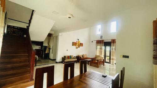 a living room with a table and a dining room at Cozy 3-Bedroom Retreat Near Colombo Maharagama in Maharagama