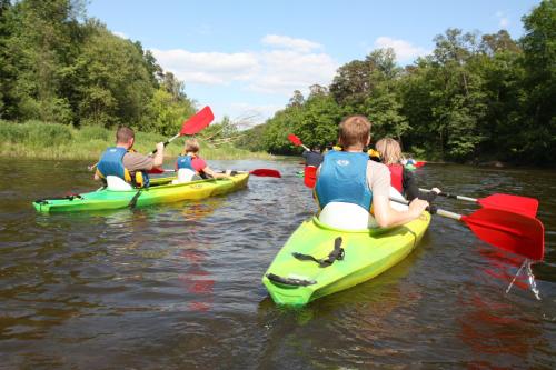 a group of people in kayaks on a river at Pensjonat Karczma Spalska in Spała