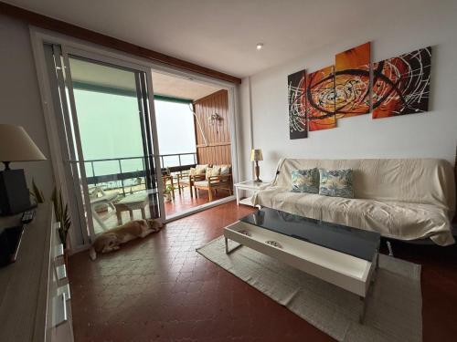 a living room with a couch and a balcony at Paseo de los Castaños con vistas in Aguadulce