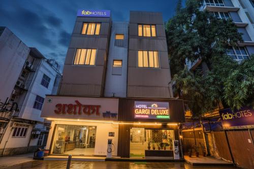 a building with lights on in front of a store at FabHotel Gargi Deluxe in Pune