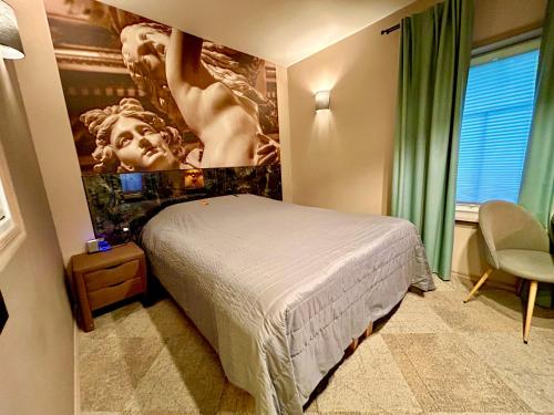 a bedroom with a bed and a painting on the wall at Traditional Narva House in Narva