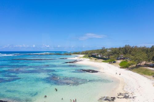 an aerial view of a beach with people in the water at THE BAY in Trou dʼ Eau Douce