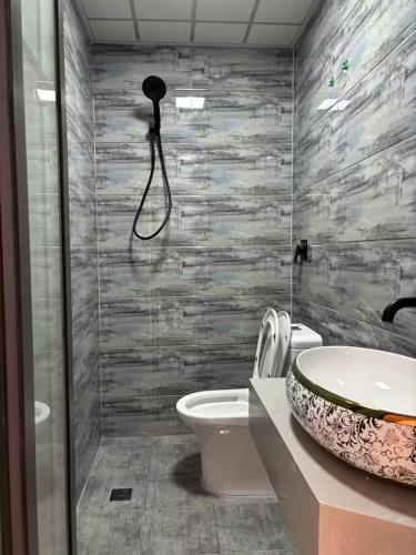a bathroom with a sink and a toilet and a shower at Snow Valley Ruixueju Boutique B&B in Huolonggou