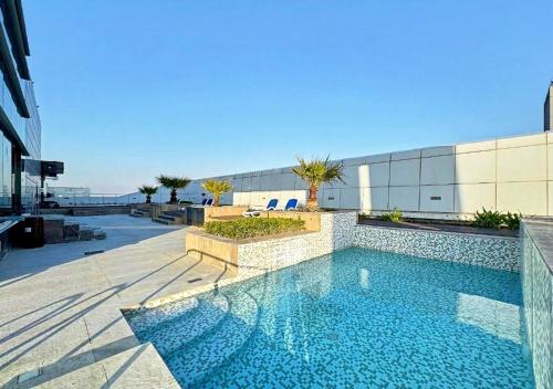a swimming pool on the side of a building at Cosmos Living Delightful Studio with Balcony in Dubai